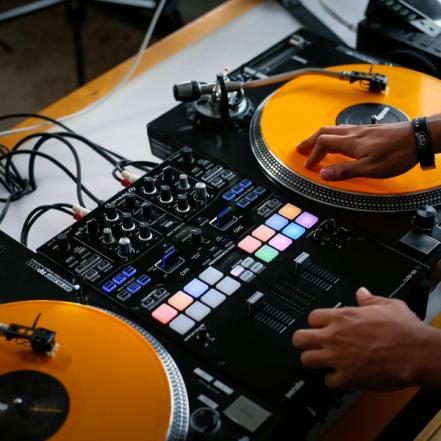 Close up of DJ's hands on a controller